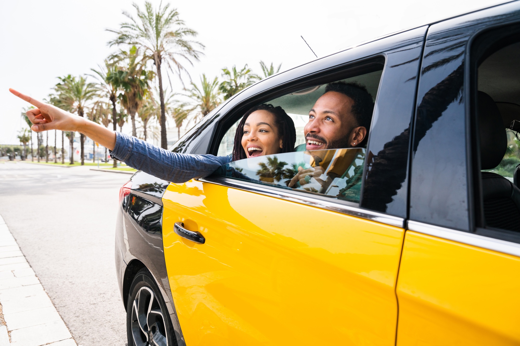 Happy hispanic latino couple taking a taxi